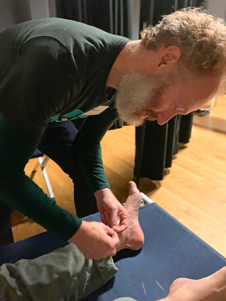 An acupuncturist works on a patient during the 2019 Kincade Fires